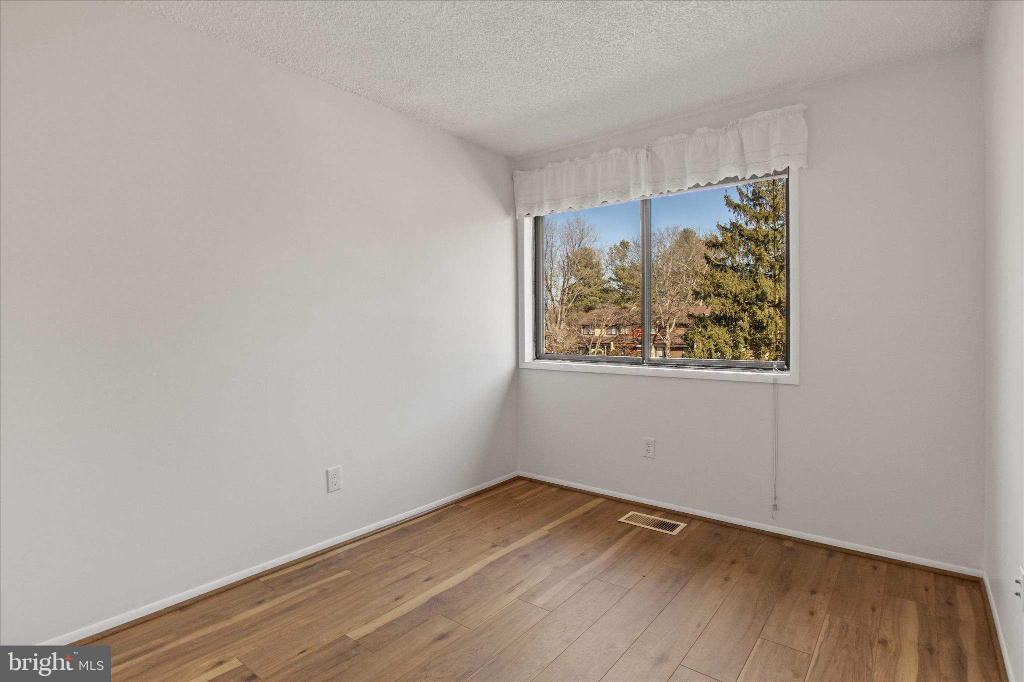 2142 Cartwright Place Reston, VA 20191 - Photo 16 of 29 a view of an empty room with wooden floor and a window