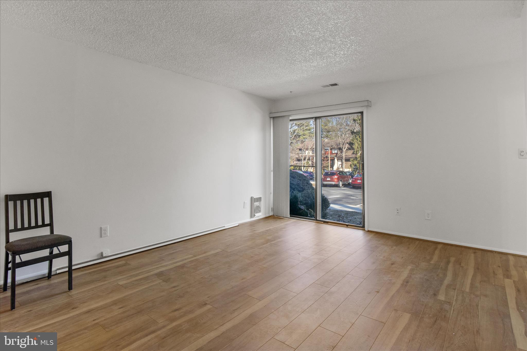 2142 Cartwright Place Reston, VA 20191 - Photo 7 of 29 a view of an empty room with a window and wooden floor