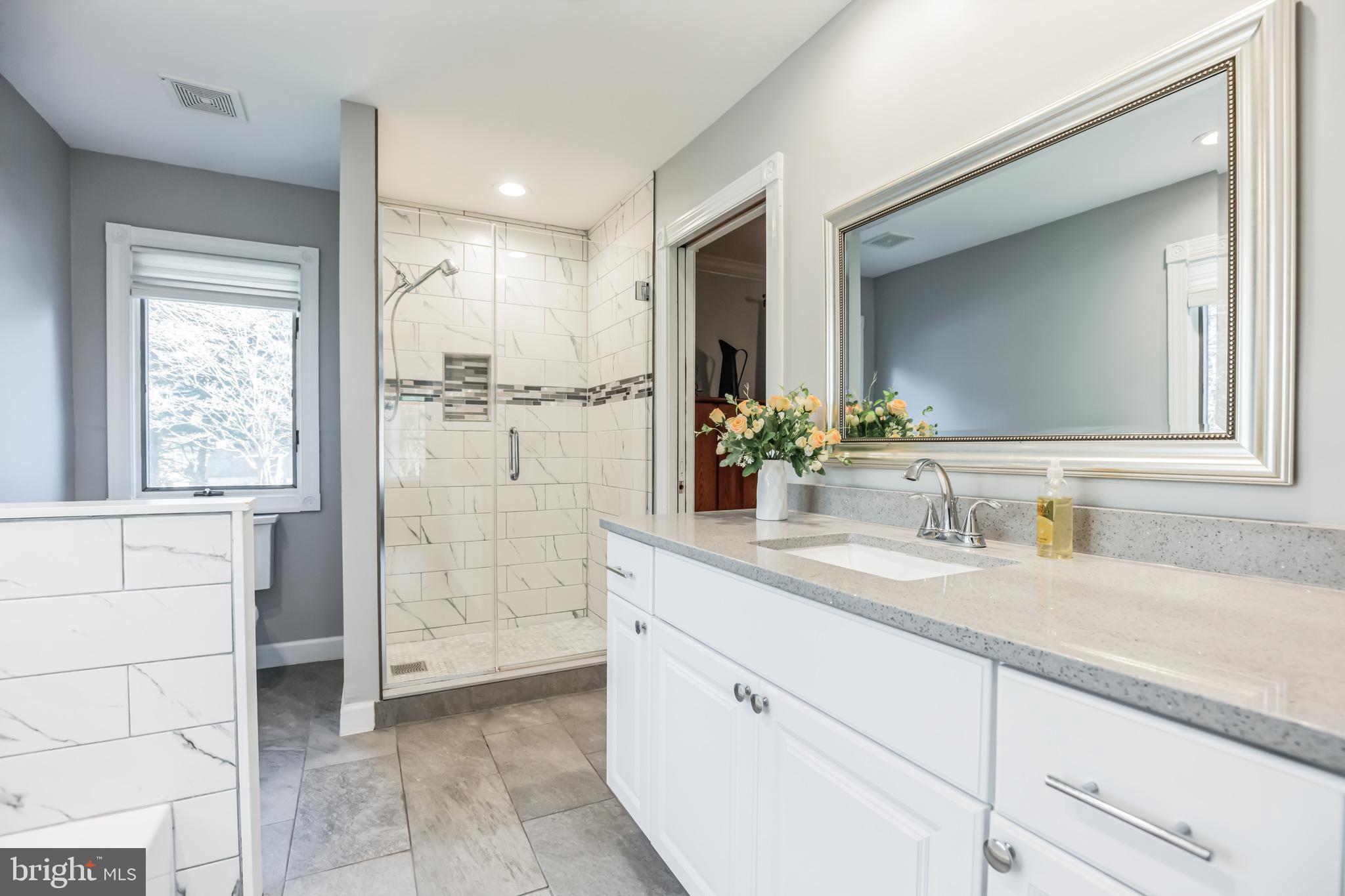 3310 Holland Cliffs Road Huntingtown, MD 20639 - Photo 28 of 40 a bathroom with a granite countertop sink mirror and double