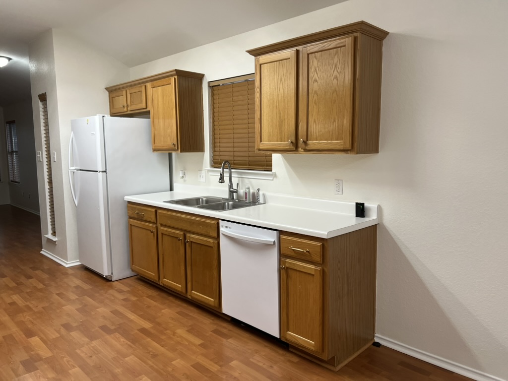 17843 Loch Linnhe Loop Pflugerville, TX 78660 - Photo 12 of 23 a kitchen with a sink cabinets and refrigerator