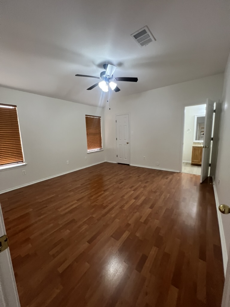 17843 Loch Linnhe Loop Pflugerville, TX 78660 - Photo 4 of 23 wooden floor in an empty room with a window