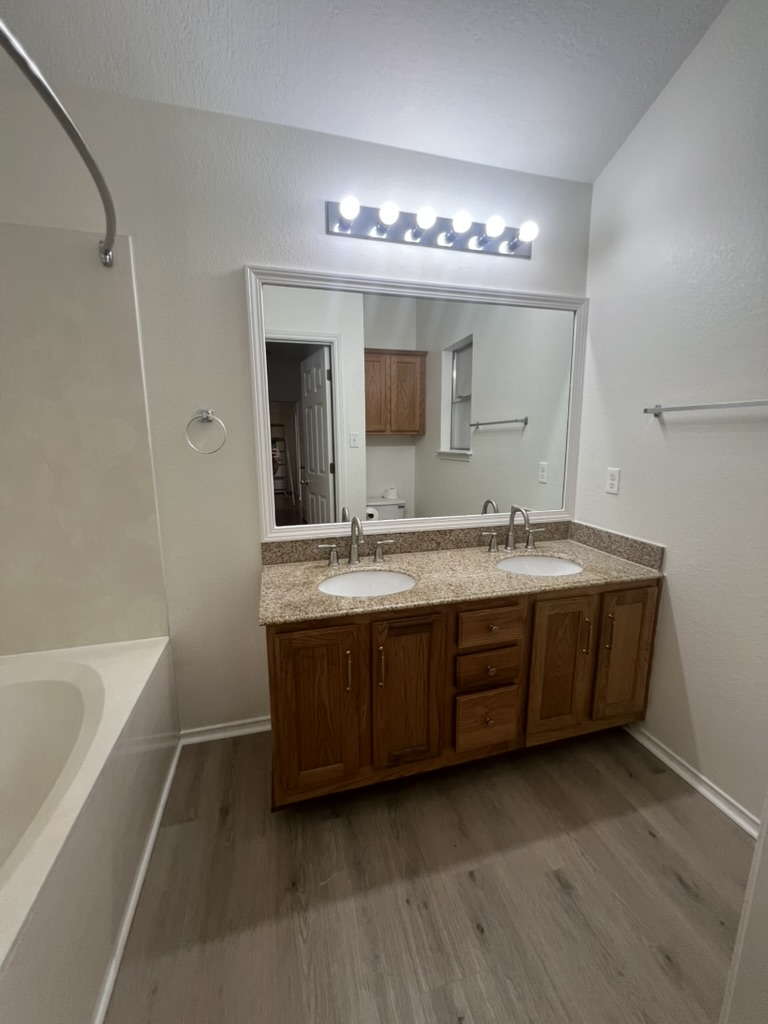 17843 Loch Linnhe Loop Pflugerville, TX 78660 - Photo 6 of 23 a bathroom with a double vanity sink and a mirror