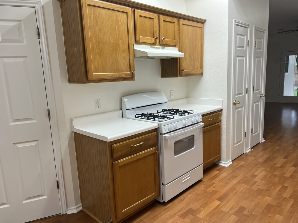 17843 Loch Linnhe Loop Pflugerville, TX 78660 - Photo 10 of 23 a kitchen with a stove and a microwave