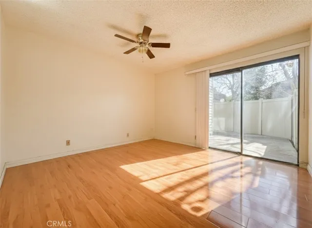 a view of a room with wooden floor and windows