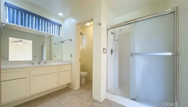 a spacious bathroom with a shower sink and mirror