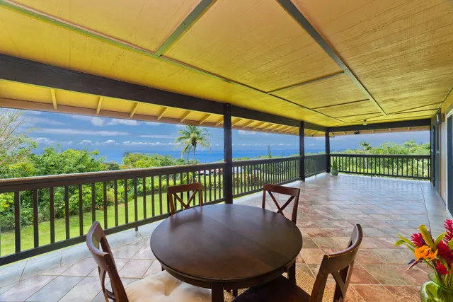 a view of a chairs and table in the balcony