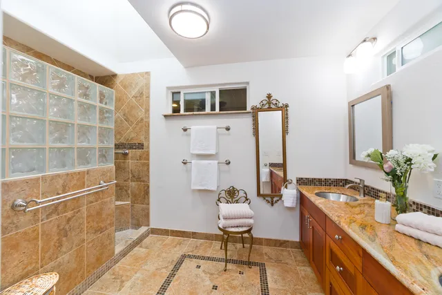 a room with furniture a rug and a potted plant