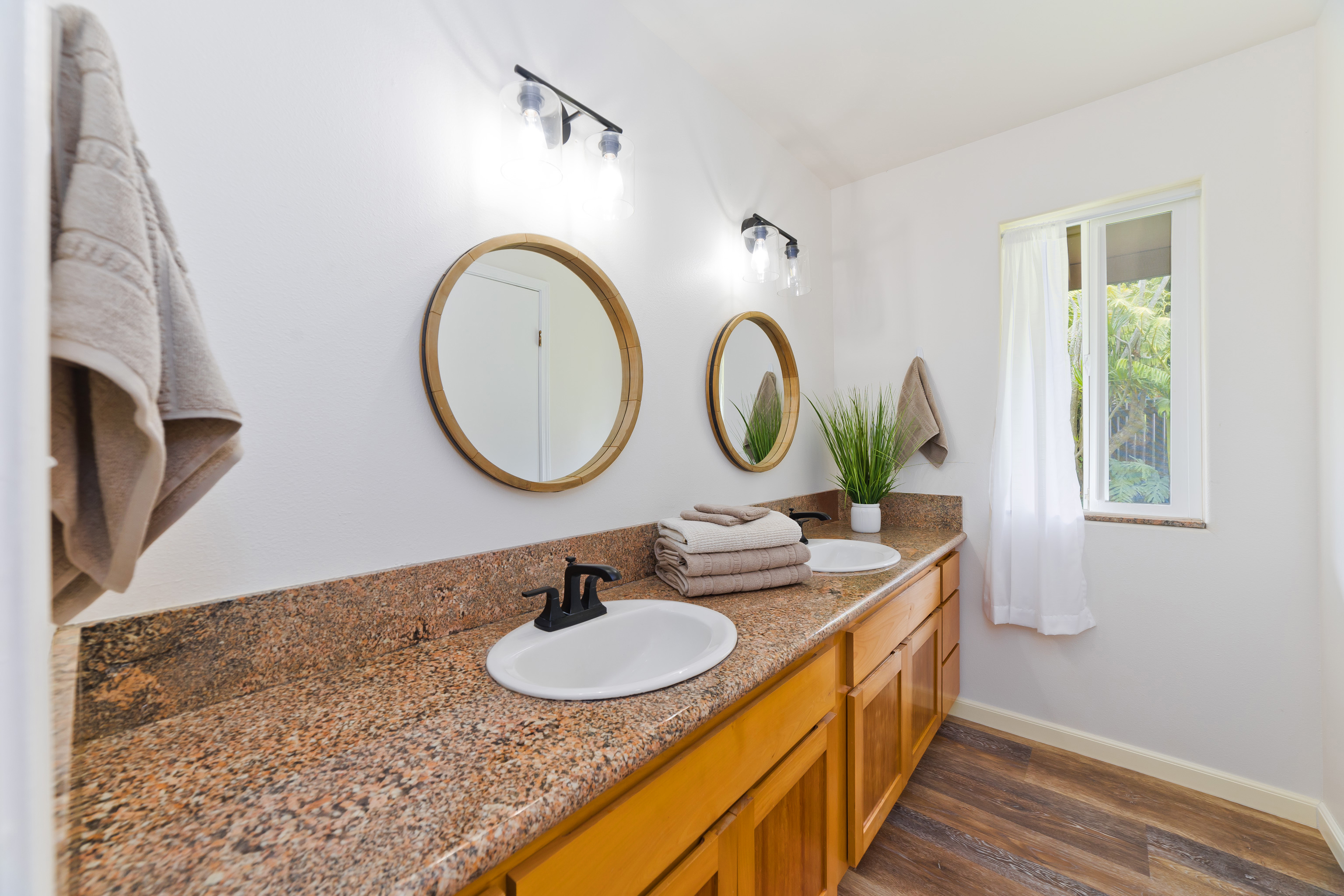 32-56 Piha Kahuku Road Ninole, HI 96773 - Photo 16 of 26 a bathroom with a double vanity sink and a mirror