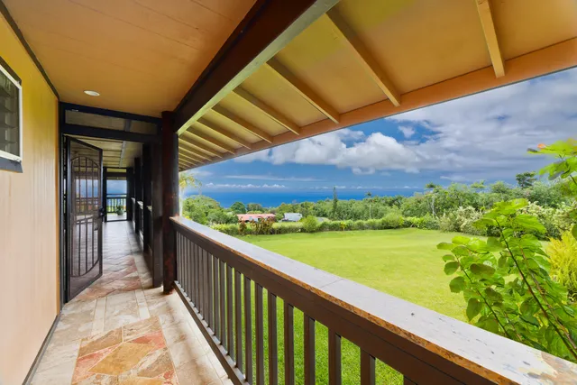 a view of a balcony with a floor to ceiling window and wooden fence