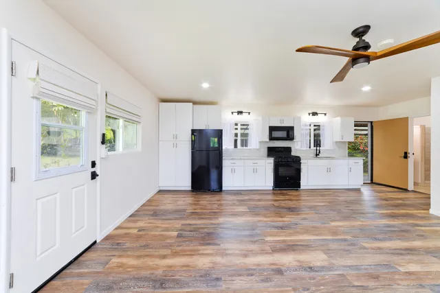a view of a kitchen with a stove cabinets and wooden floor