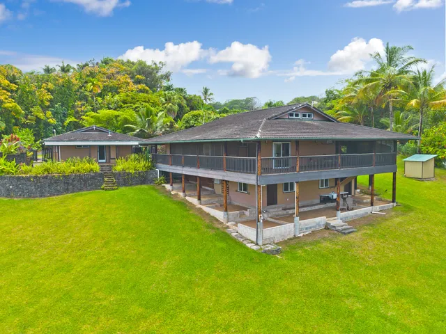 a view of a house with a backyard porch and sitting area