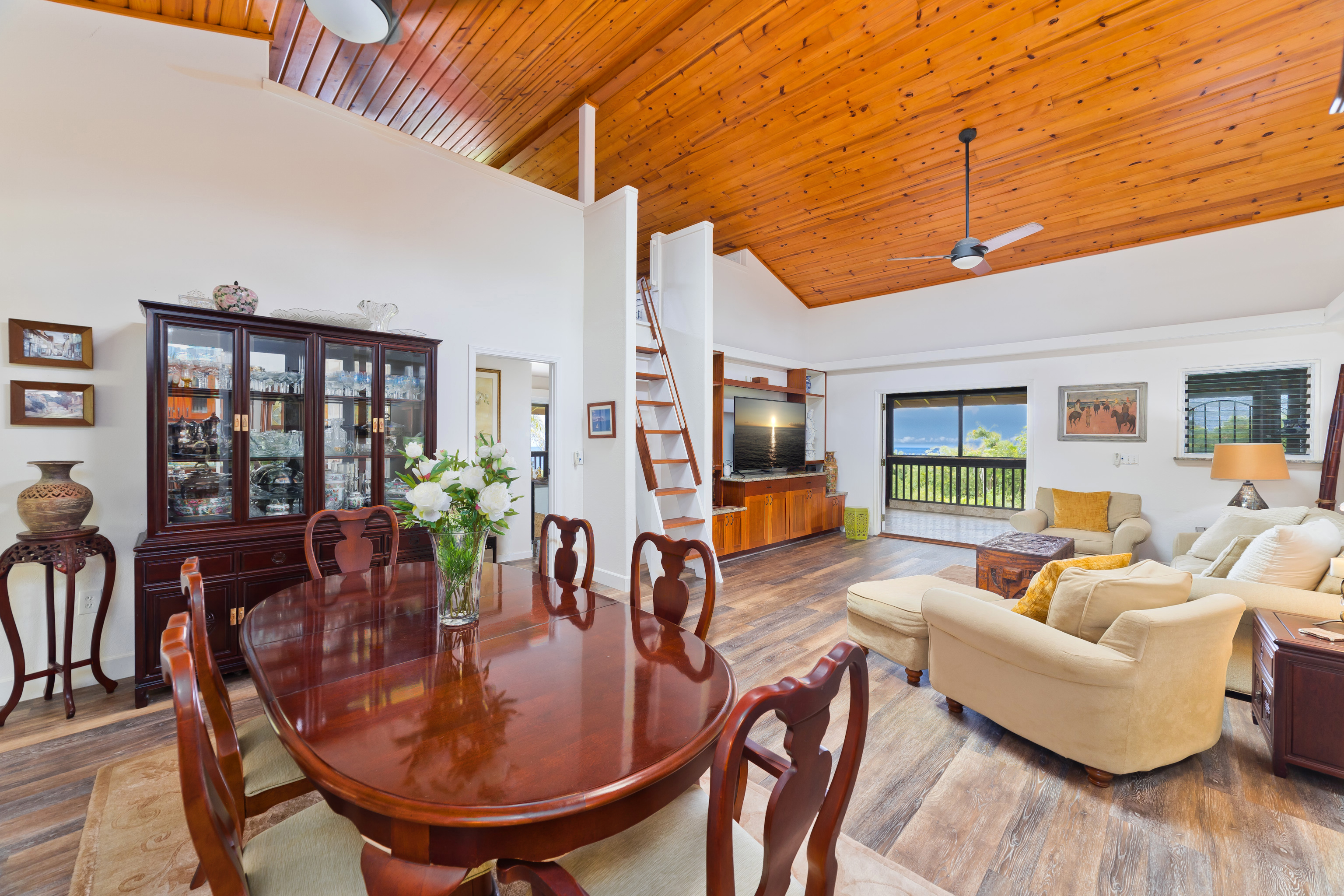 32-56 Piha Kahuku Road Ninole, HI 96773 - Photo 4 of 26 a dining room with furniture a rug and wooden floor