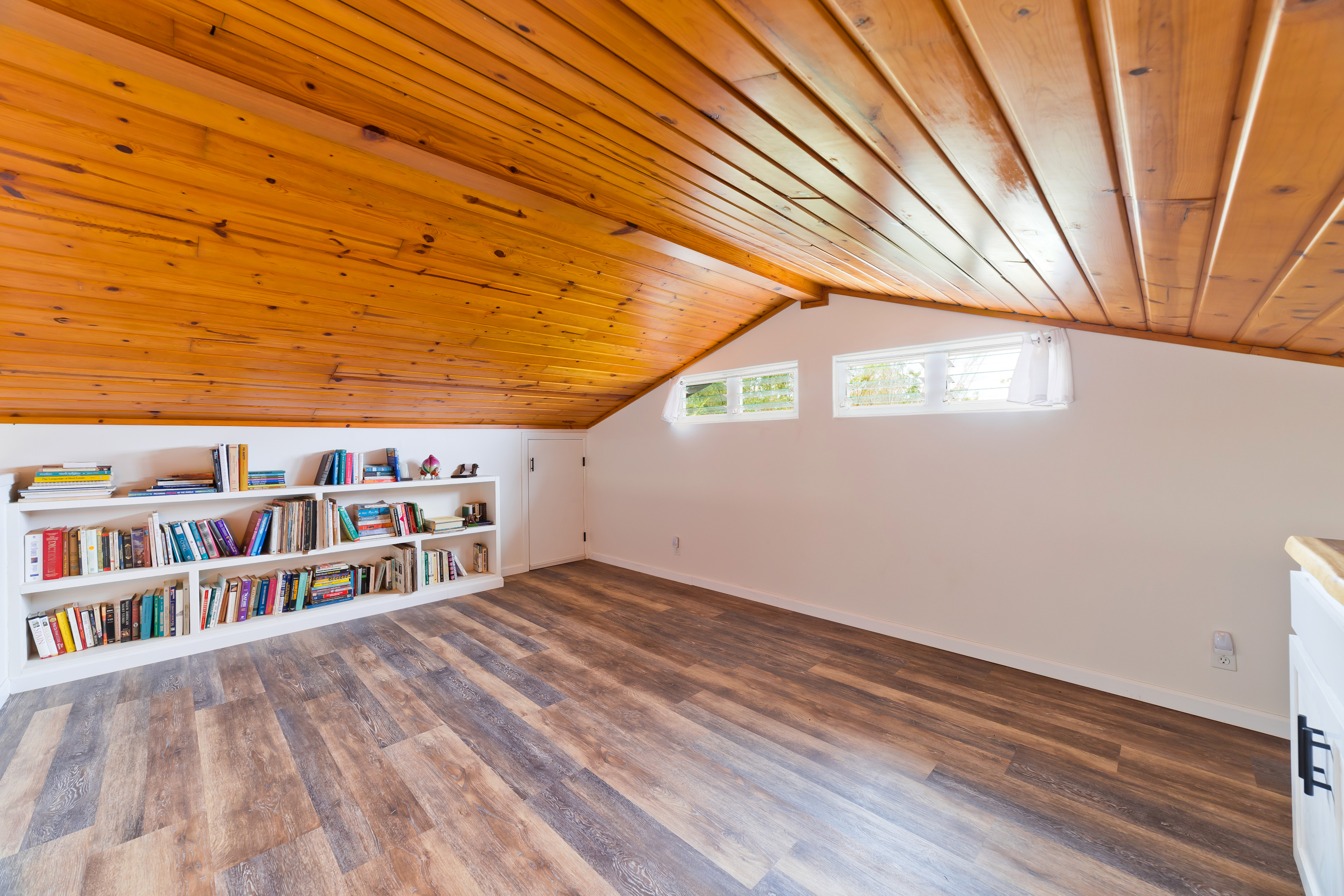 32-56 Piha Kahuku Road Ninole, HI 96773 - Photo 5 of 26 a view of a balcony with wooden floor and fence