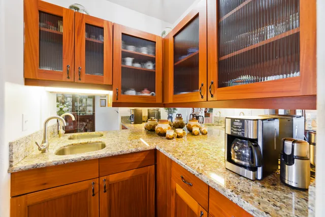 a kitchen with stainless steel appliances granite countertop a sink and a stove