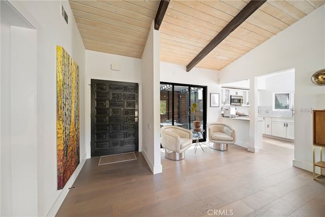 a living room with furniture and floor to ceiling window