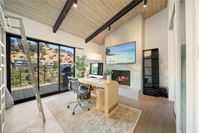 a view of a livingroom with workspace and a window