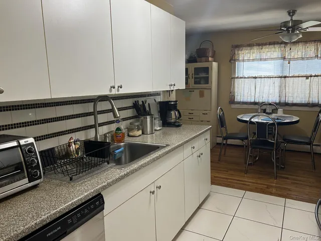 a kitchen with sink and cabinets