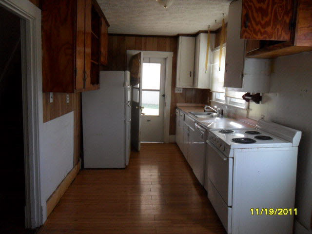 59 Valley Church Road Weyers Cave, VA 24486 - Photo 2 of 8 a kitchen with stainless steel appliances granite countertop a refrigerator a stove and a wooden floors
