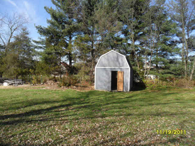 59 Valley Church Road Weyers Cave, VA 24486 - Photo 7 of 8 a large stone house with a big yard and large trees