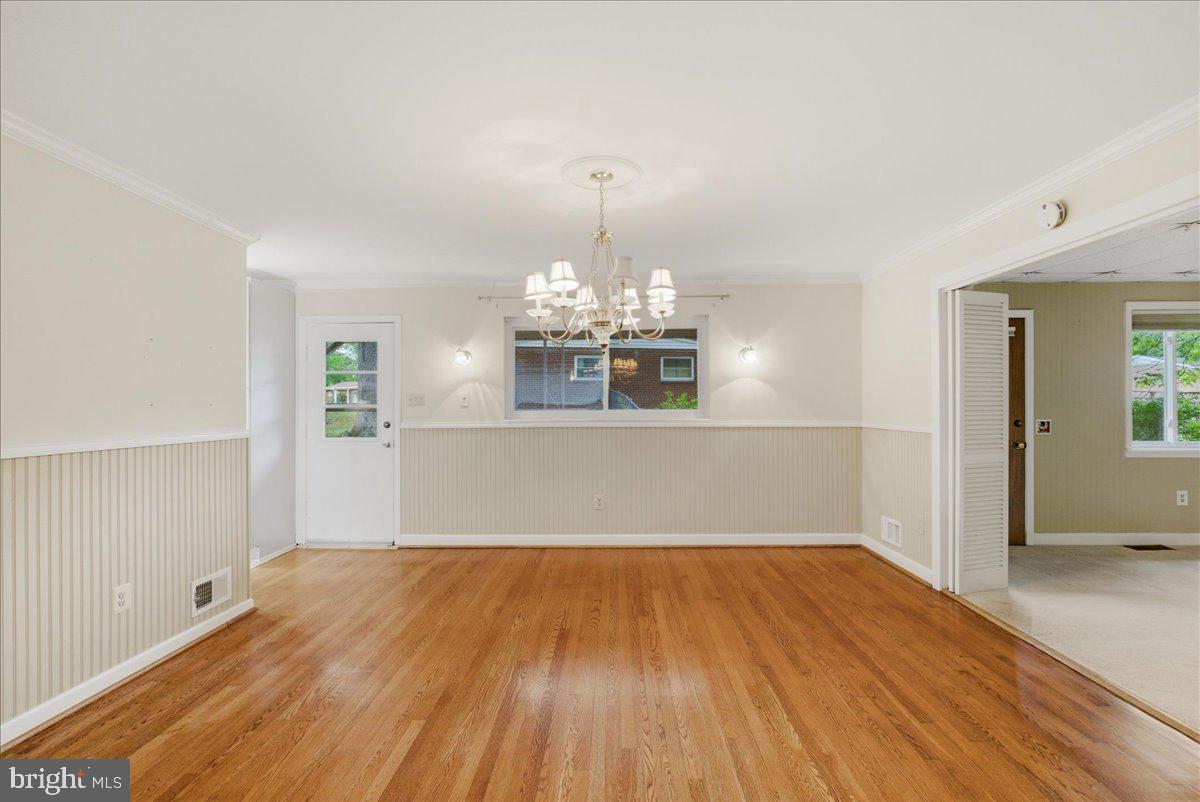 18309 Cabin Road Triangle, VA 22172 - Photo 11 of 42 a view of a room with wooden floor chandelier and windows