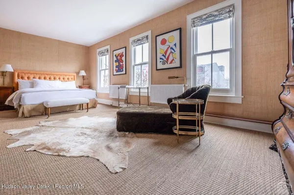 a living room with furniture a bed and a window