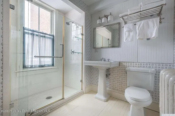 a bathroom with a toilet sink and shower