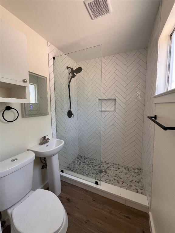 4712 Depew Avenue, Unit 106 Austin, TX 78751 - Photo 11 of 13 a bathroom with a sink a toilet a mirror and shower