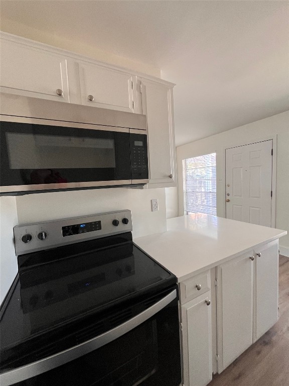 4712 Depew Avenue, Unit 106 Austin, TX 78751 - Photo 6 of 13 a kitchen with a stove and a microwave