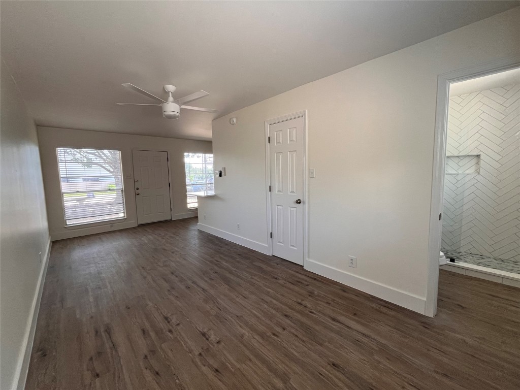 4712 Depew Avenue, Unit 106 Austin, TX 78751 - Photo 8 of 13 an empty room with wooden floor and windows