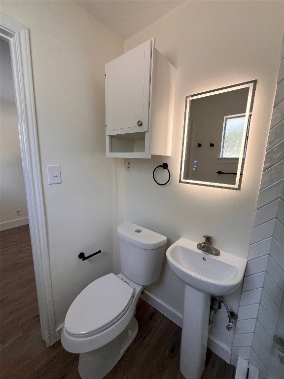 4712 Depew Avenue, Unit 106 Austin, TX 78751 - Photo 10 of 13 a bathroom with a toilet a sink and mirror