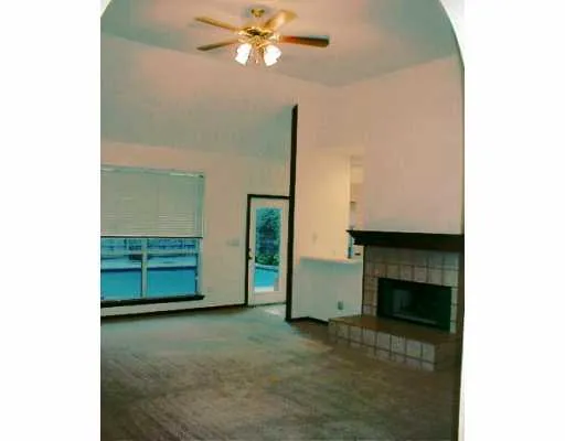 a view of an empty room with a fireplace