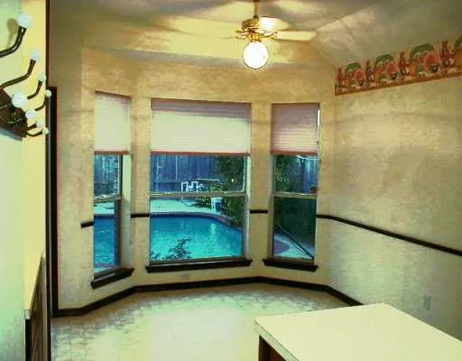 a room with a wooden floor and a fireplace