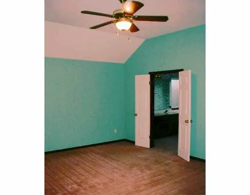 a view of a room with a fan and a ceiling fan