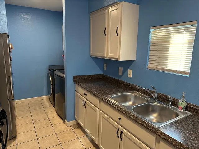 a kitchen with a sink cabinets and utility