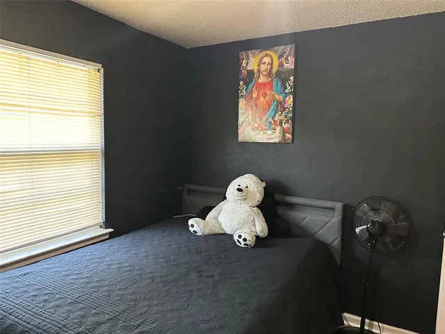 a bedroom with furniture and window