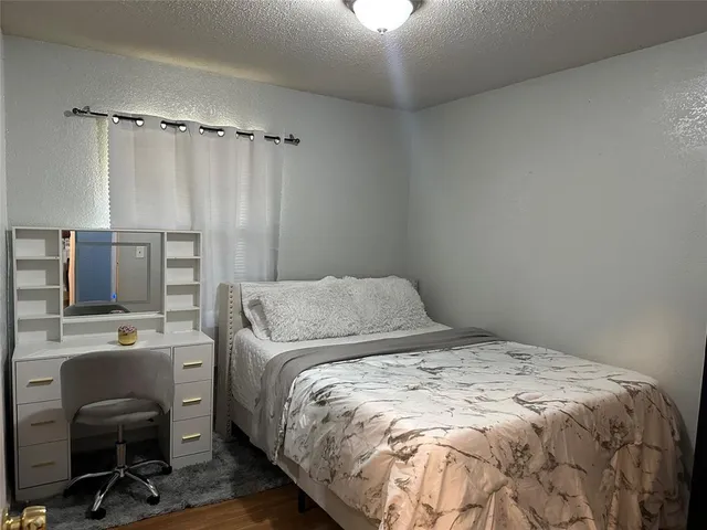a view of a yard in front of a house with large trees