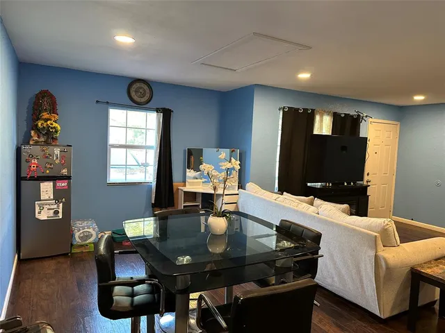 a view of a dining room with furniture and wooden floor