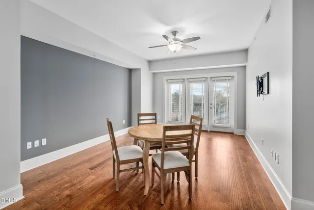 a dining room with furniture wooden floor and a chandelier