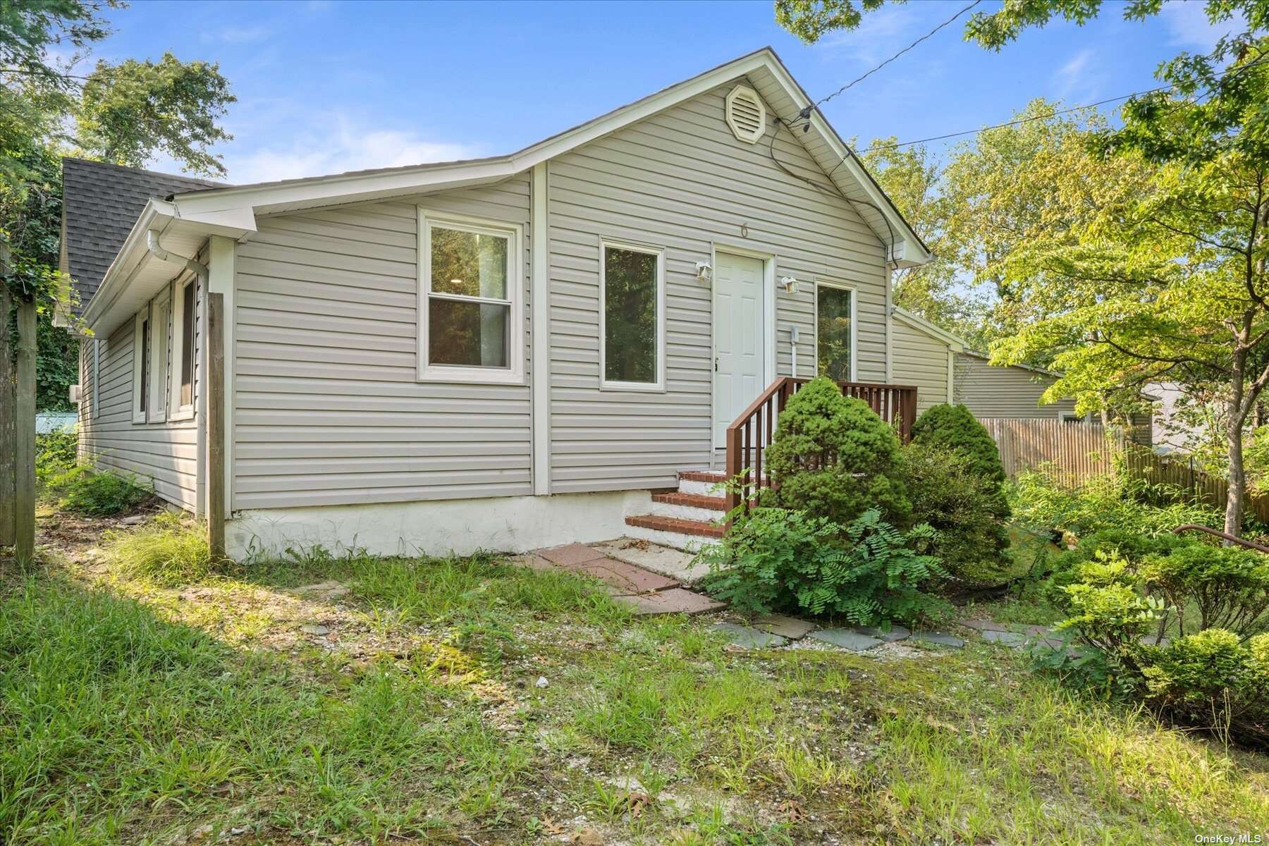 6 Tamarack Road Rocky Point, NY 11778 - Photo 1 of 1 a view of a backyard with plants and large tree