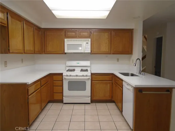 a kitchen with a sink stove top oven and cabinets