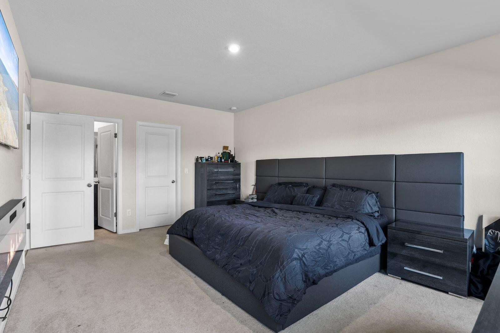 185 Dabou Loop Belle Glade, FL 33430 - Photo 11 of 25 a bedroom with a bed and a closet