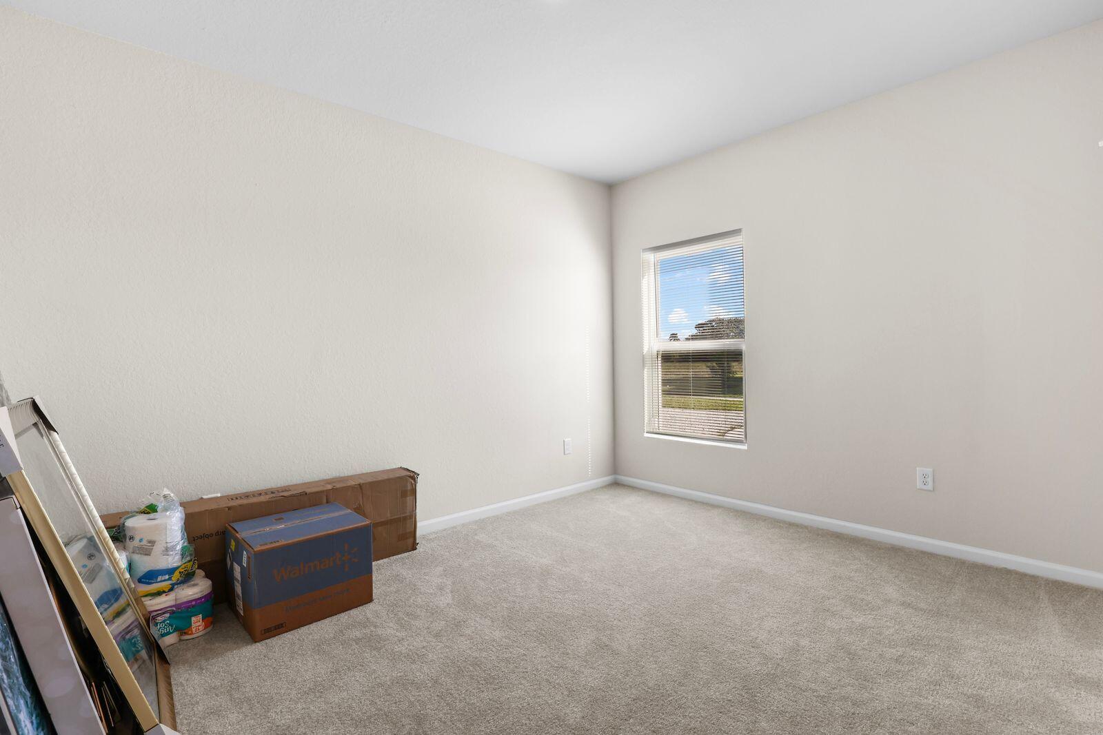 185 Dabou Loop Belle Glade, FL 33430 - Photo 17 of 25 a room with furniture and a window