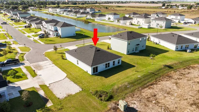 an aerial view of a house with a ocean view