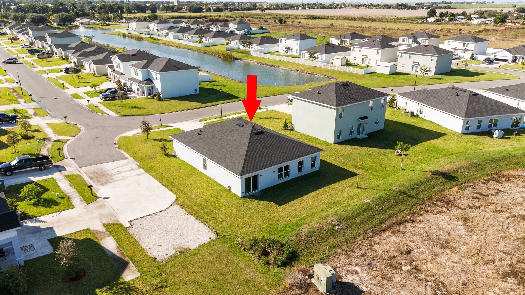 185 Dabou Loop Belle Glade, FL 33430 - Photo 23 of 25 an aerial view of a house with a swimming pool