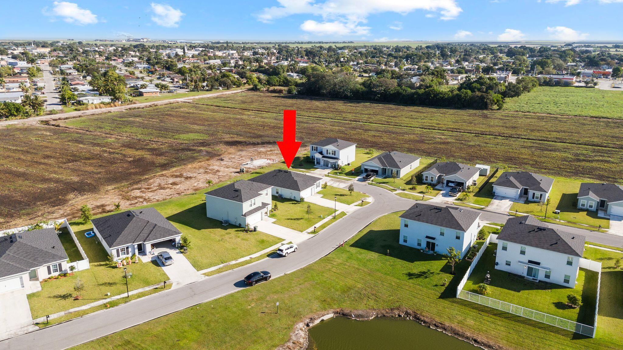 185 Dabou Loop Belle Glade, FL 33430 - Photo 25 of 25 a view of a swimming pool with lounge chairs