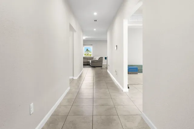 a view of a hallway with a couch and a potted plant