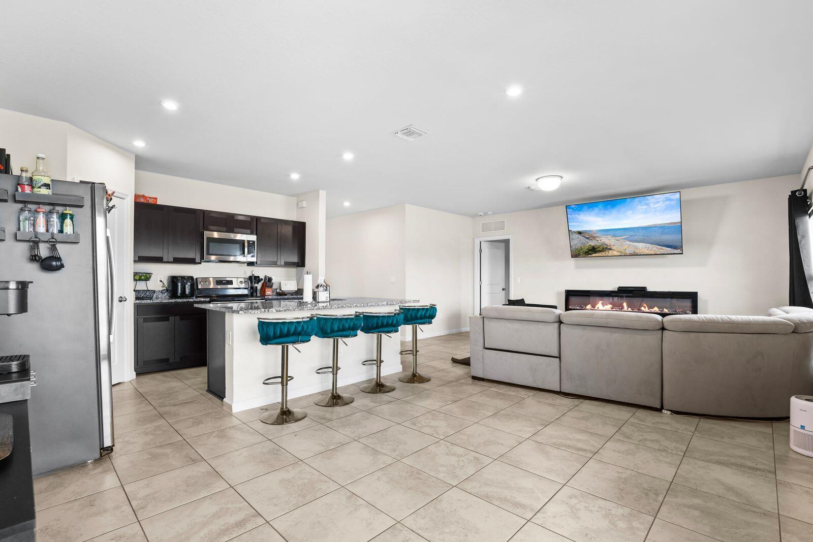 185 Dabou Loop Belle Glade, FL 33430 - Photo 7 of 25 a kitchen with white cabinets and stainless steel appliances