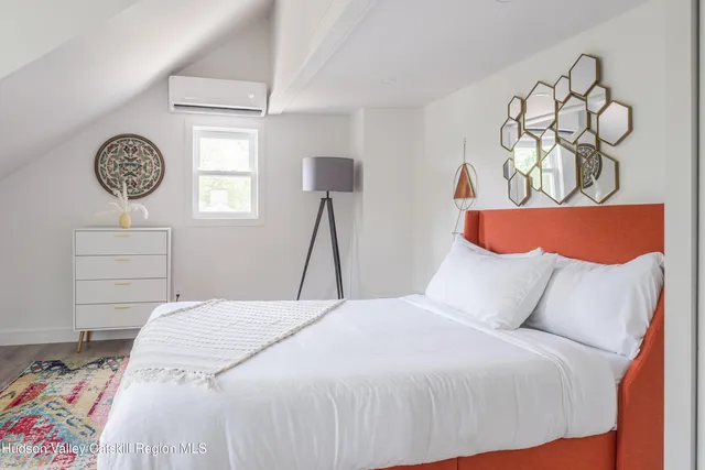 a bedroom with a bed and a window