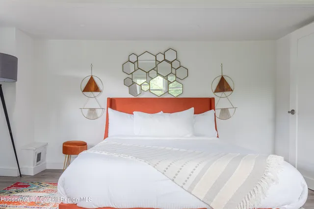 a bedroom with a bed and a painting on the wall