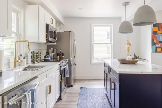 a kitchen with stainless steel appliances granite countertop a sink stove and cabinets